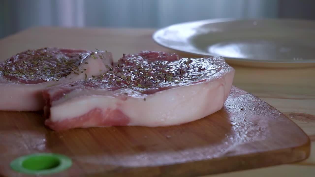Seasoning Fresh Pork Steaks Stock Video Motion Array