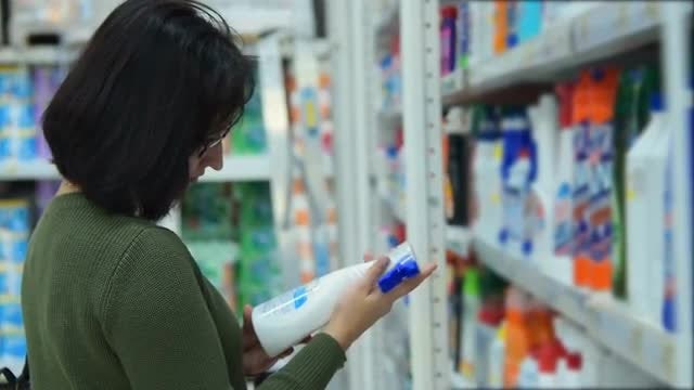 Woman Buying Cleaning Products: Stock Video