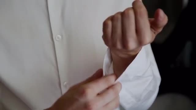 Man Puts On Cufflink: Stock Video