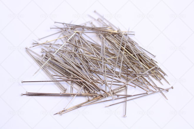 Seven colorful sewing pins on a white background, Stock image