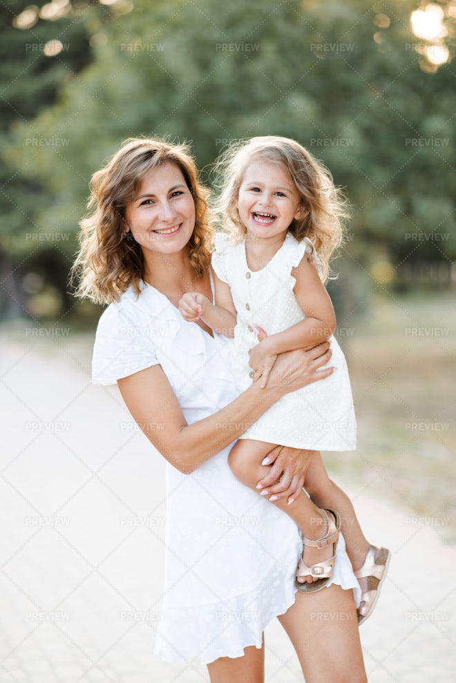 Mother Holding Her Child Outdoor - Stock Photos | Motion Array