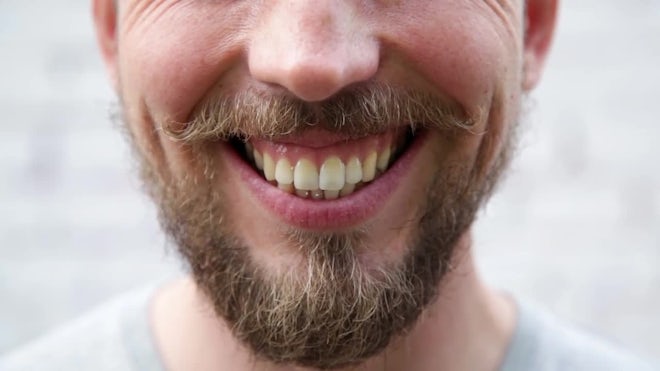 A CLOSE UP of a man smiling menacingly, , Stock Video