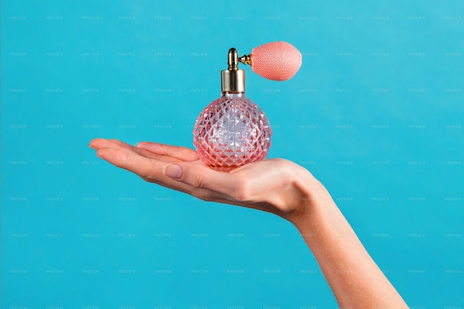 Woman Showing Classic Perfume Bottle - Stock Photos | Motion Array