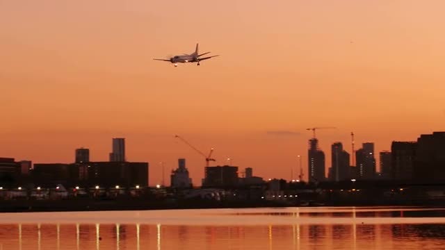Airplane Landing At Sunset: Stock Video