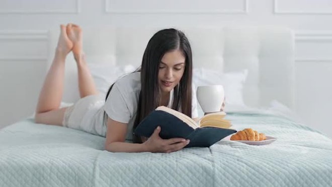 Girl Reading In Bed - Stock Video | Motion Array