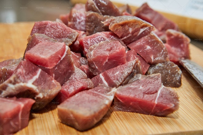 Fresh raw diced red beef meat (chopped in cubes) in a styrofoam container  with copy space for text. Weighing diced meat on scales Stock Photo - Alamy