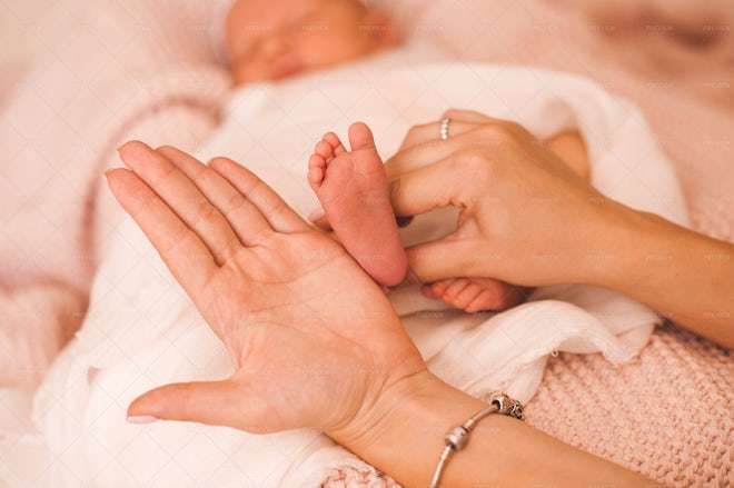 mother-holding-baby-foot-stock-photos-motion-array