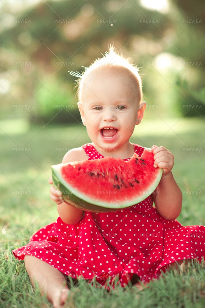 Girl Eating Watermelon Sitting On Green Grass - Stock Photos | Motion Array