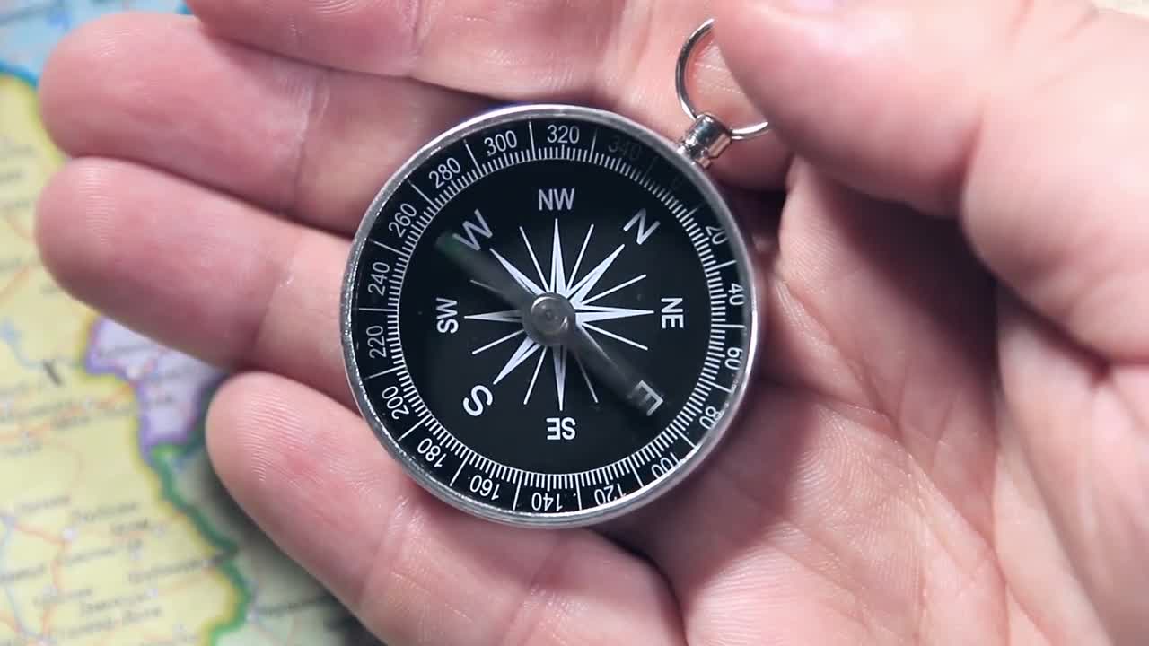 Hand Holding Spinning Compass - Stock Video | Motion Array