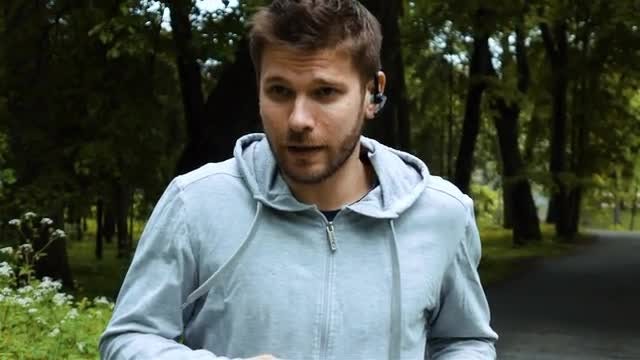 Runs With Bluetooth Headset: Stock Video