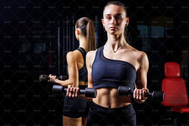 Bodybuilder Doing Biceps Curls Standing Near The Mirror - Stock Photos 