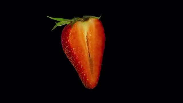 Isolated Strawberry Slice: Stock Video