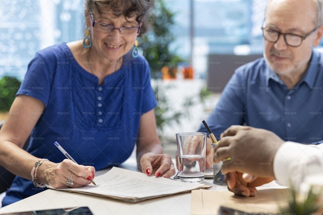 Mature Woman Signing Retirement Planning Contract To Secure The Pension 