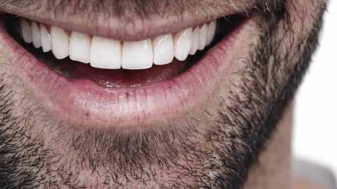 A CLOSE UP of a man smiling menacingly, , Stock Video