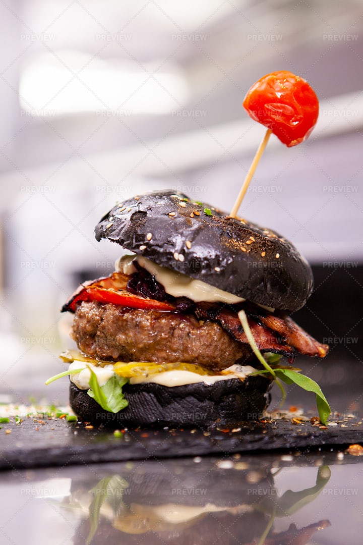 Black Burger On Stone Cutting Board: Stock Photos