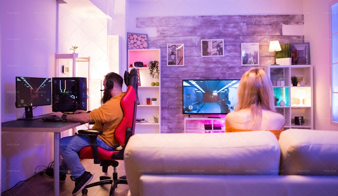 Man gamer teaching his girlfriend playing space shooter video game Stock  Photo by ©DragosCondreaW 465086788