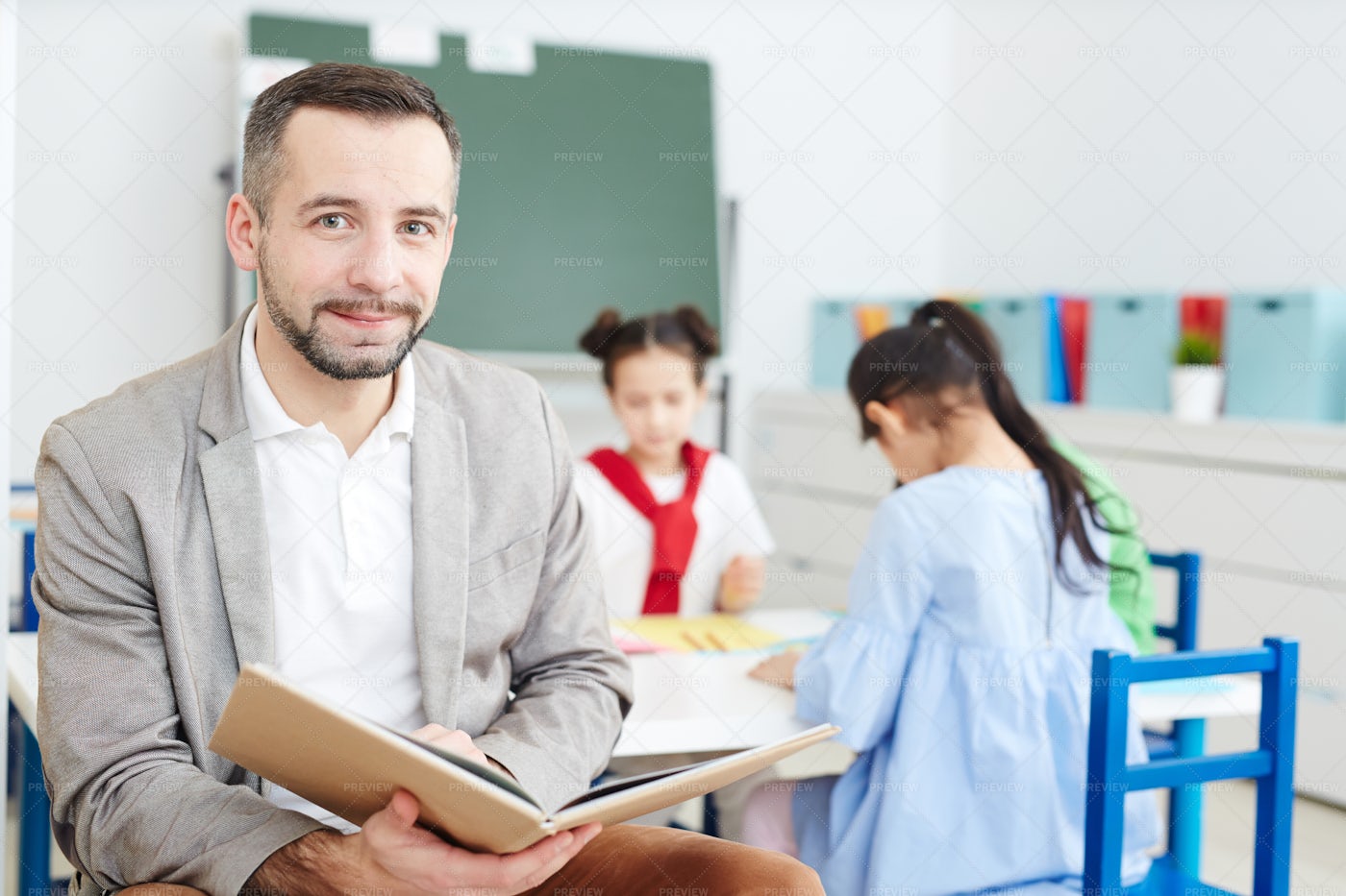 Teacher With Book - Stock Photos | Motion Array