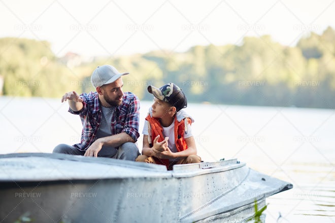 A man and a boy fishing from a boat - Stock Image - F009/2257