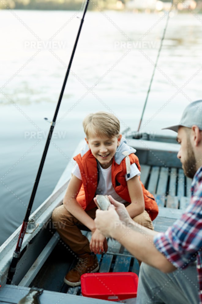 A man and a boy fishing from a boat - Stock Image - F009/2257