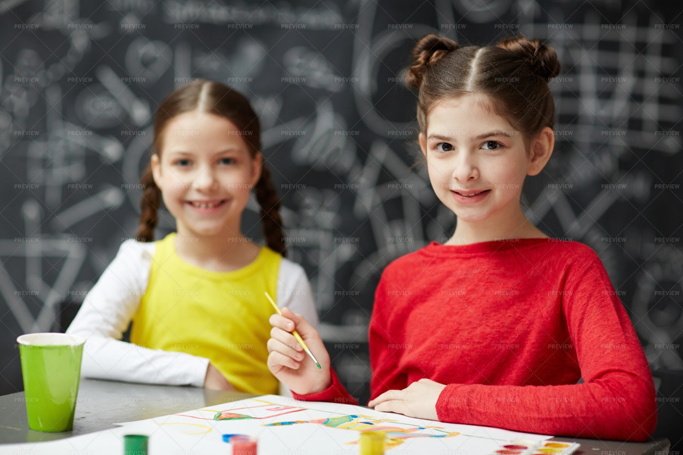 Two Little Girls Painting Together: Stock Photos