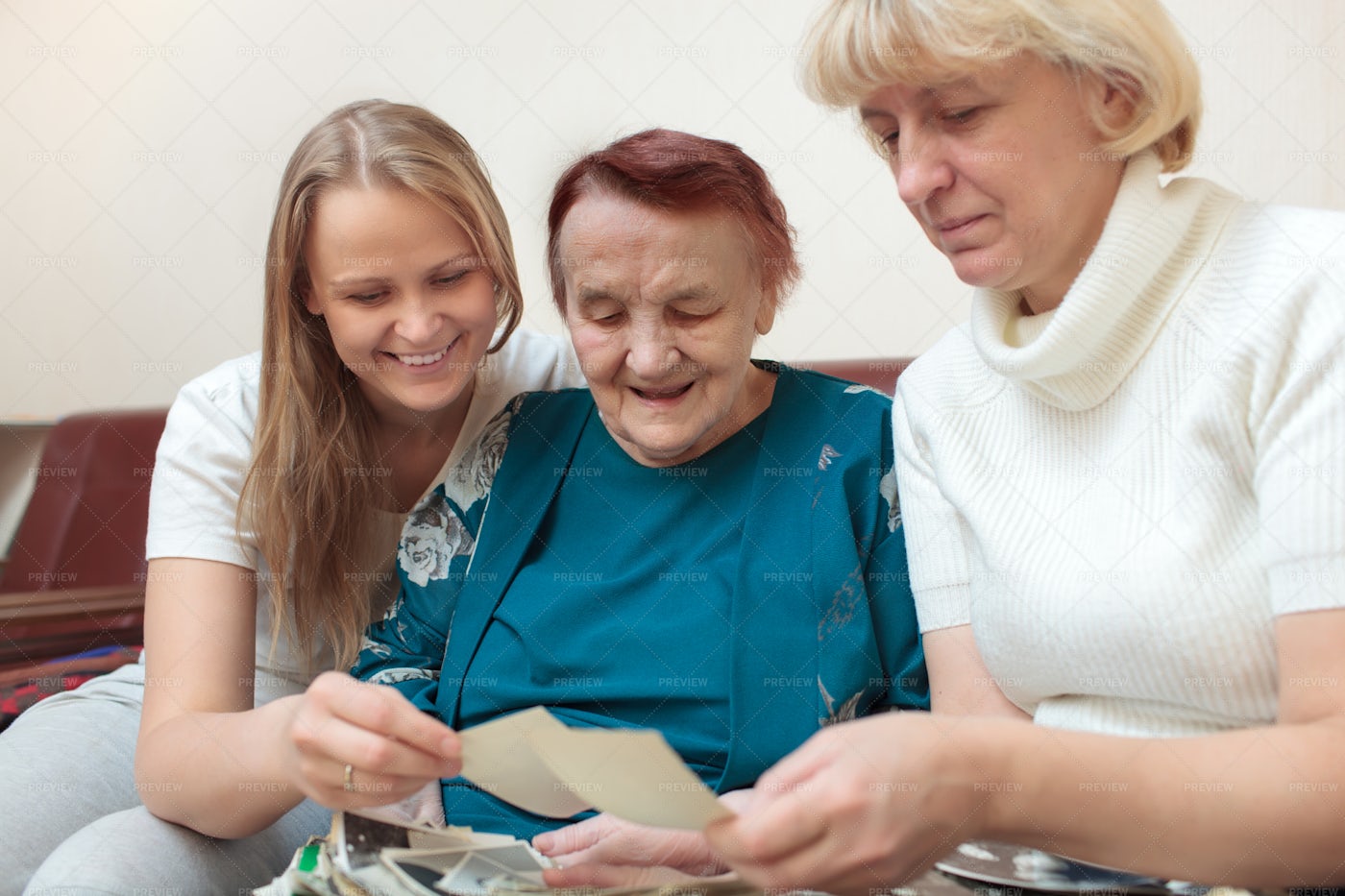 Three Generations Looking At Pictures: Stock Photos