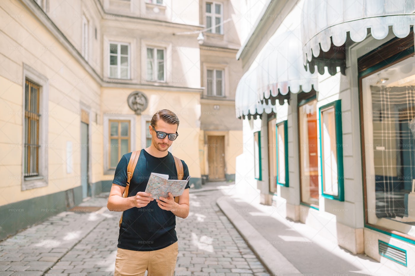 Tourist With A Map And A Backpack: Stock Photos