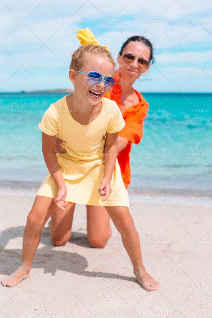 Playing With Mom On The Beach: Stock Photos