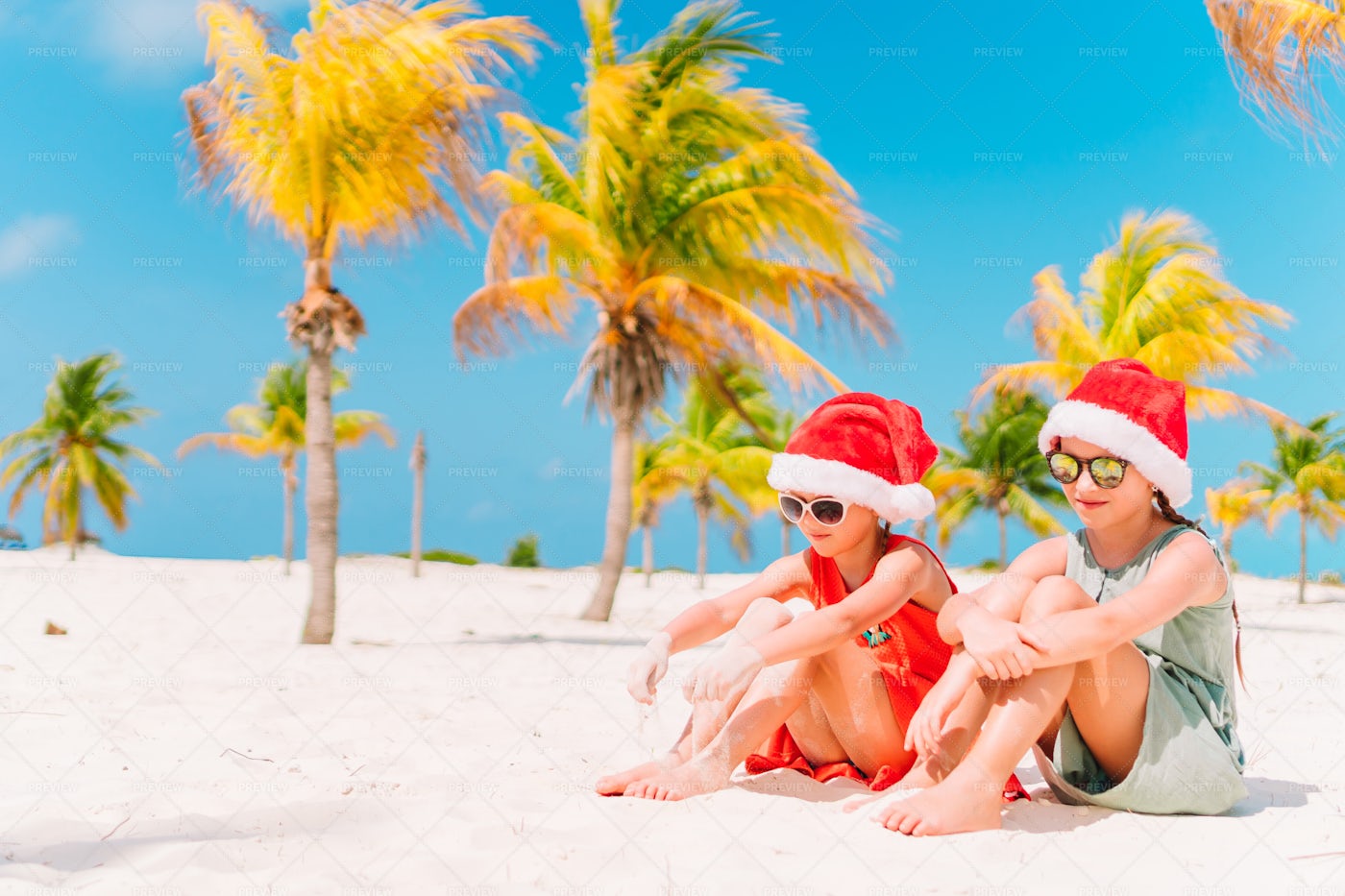 Santa Girls On The Beach: Stock Photos