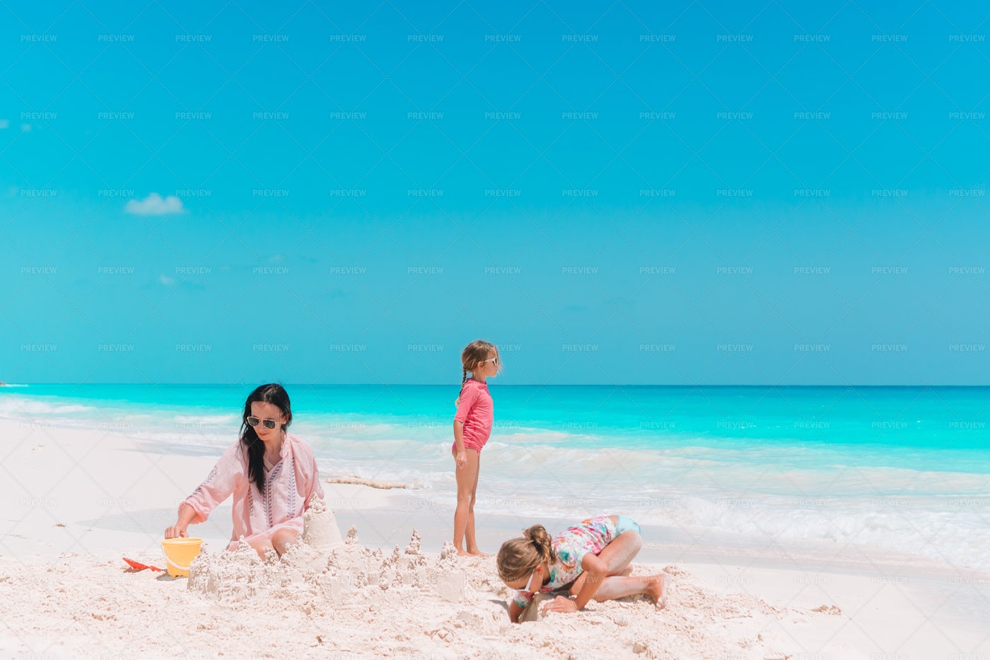 Family Making A Sand Castle: Stock Photos
