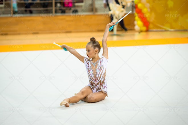 Beautiful little girl gymnast performs in competitions Stock Photo