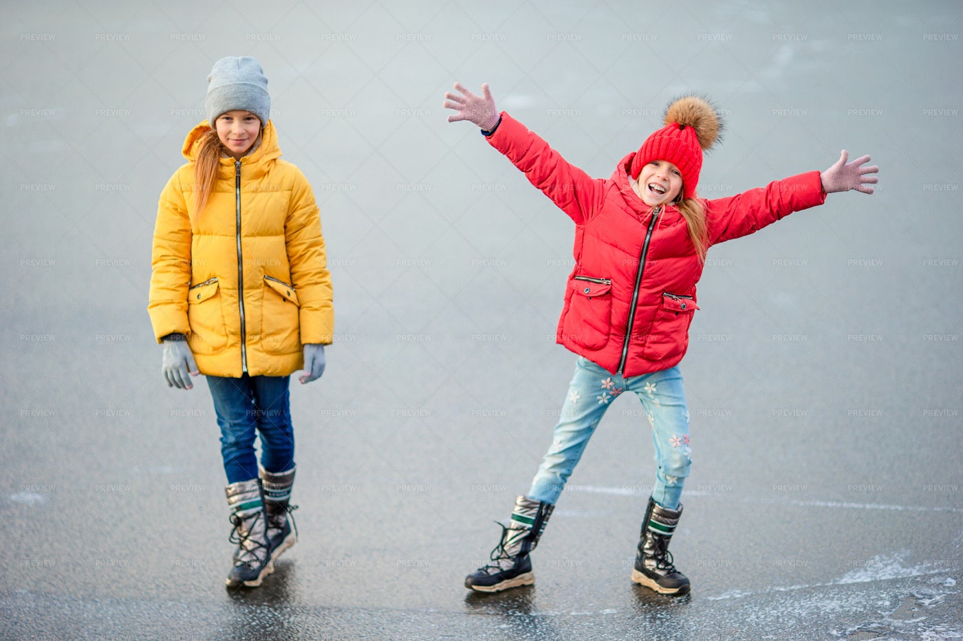 Sisters On Frozen Lake: Stock Photos