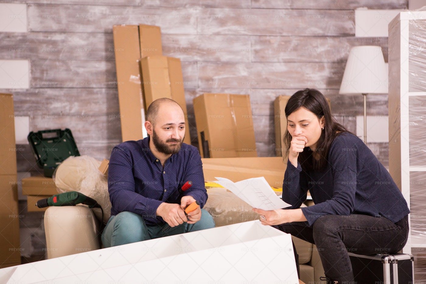 Hopeless Couple Assembling Furniture: Stock Photos