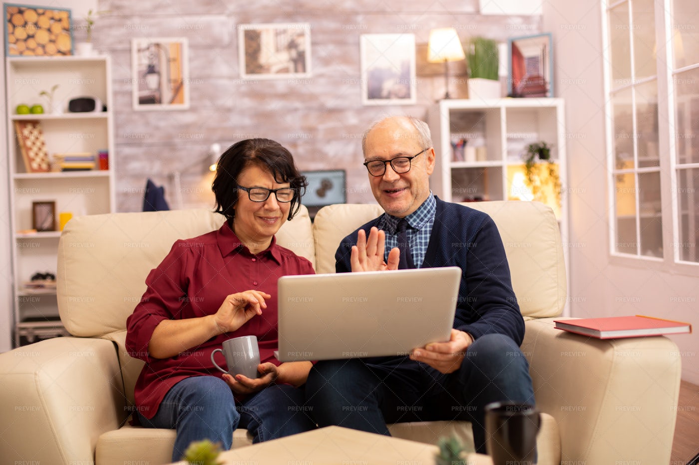 Elderly Couple Wave On Video Call: Stock Photos