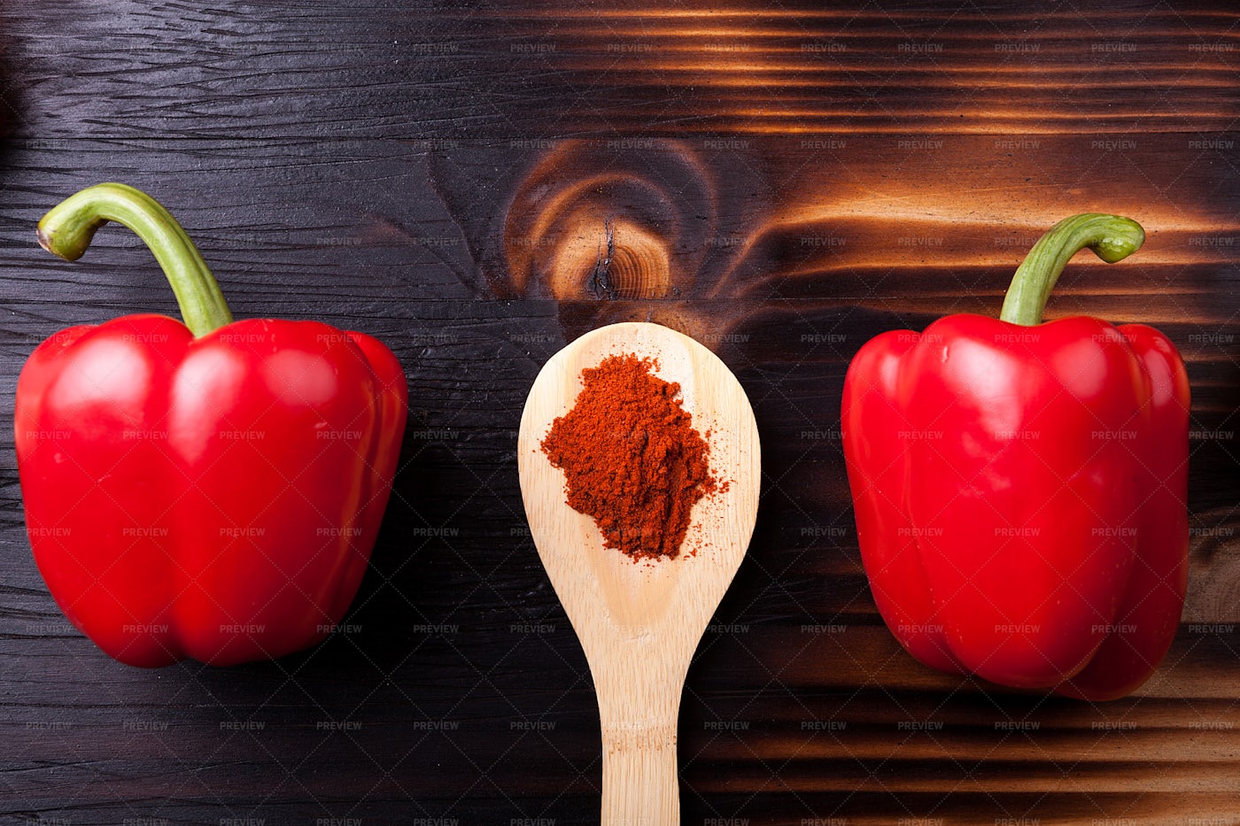 Two Sweet Red Pepper And A Wooden Spoon: Stock Photos