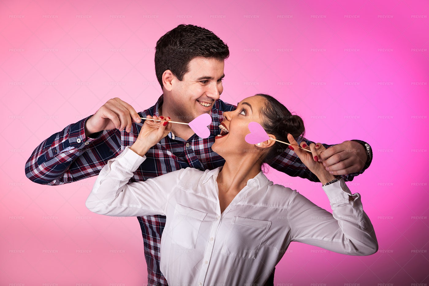 Couple In Studio With Two Pink Hearts: Stock Photos