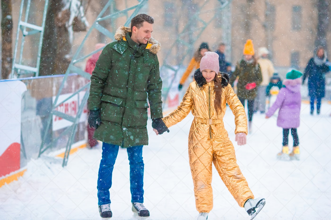 Dad And Daughter Ice Skating: Stock Photos