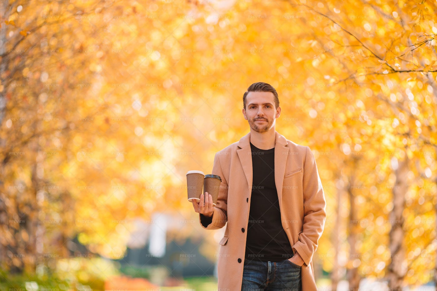 Holding Two Coffee Cups: Stock Photos