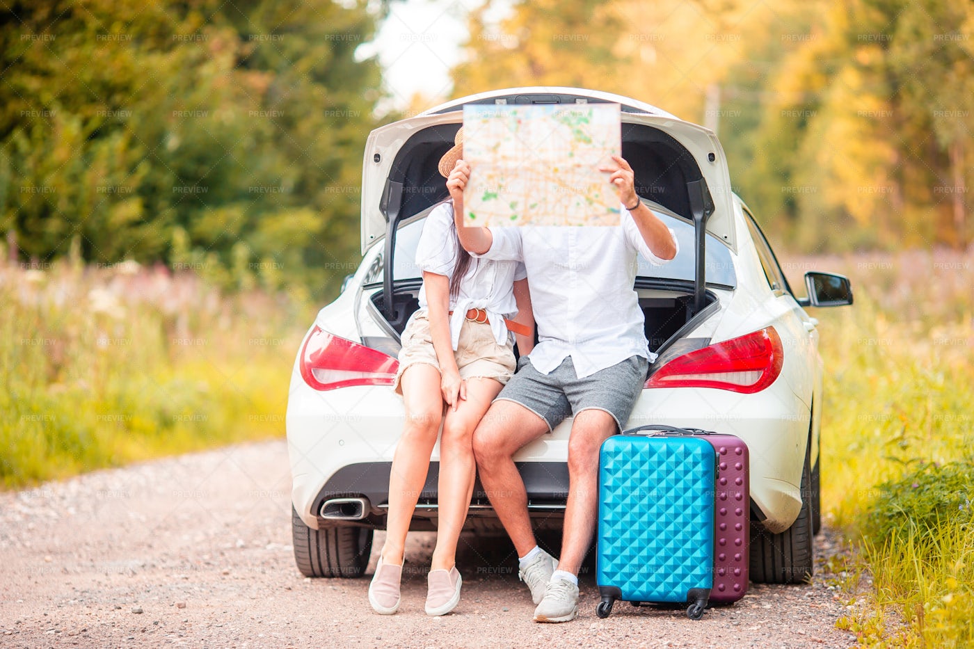 Reading A Map In The Car Trunk: Stock Photos