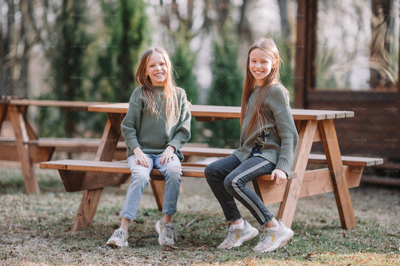 Friends Sitting At Park Bench: Stock Photos