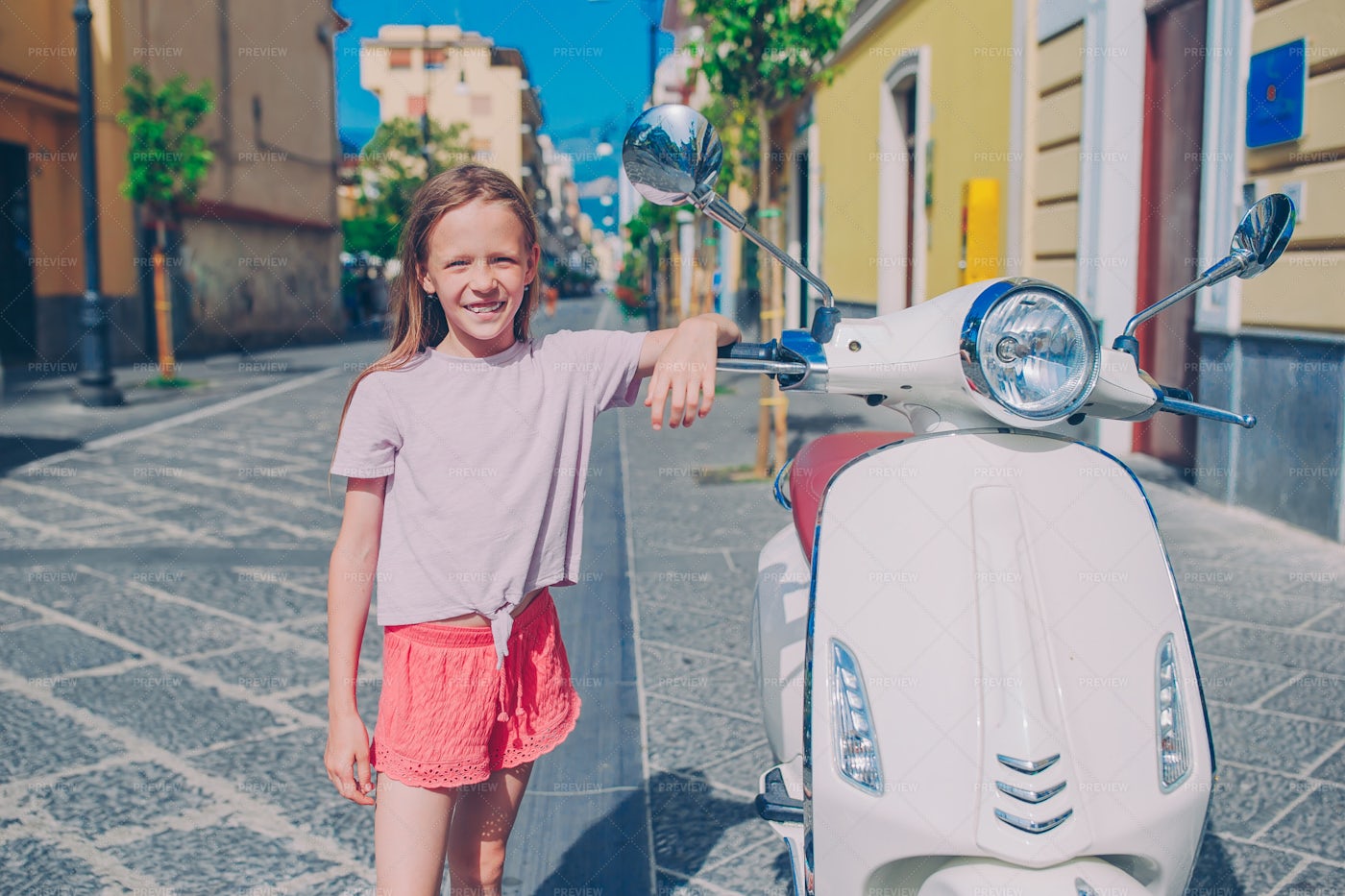 Little Girl Next To A Scooter: Stock Photos