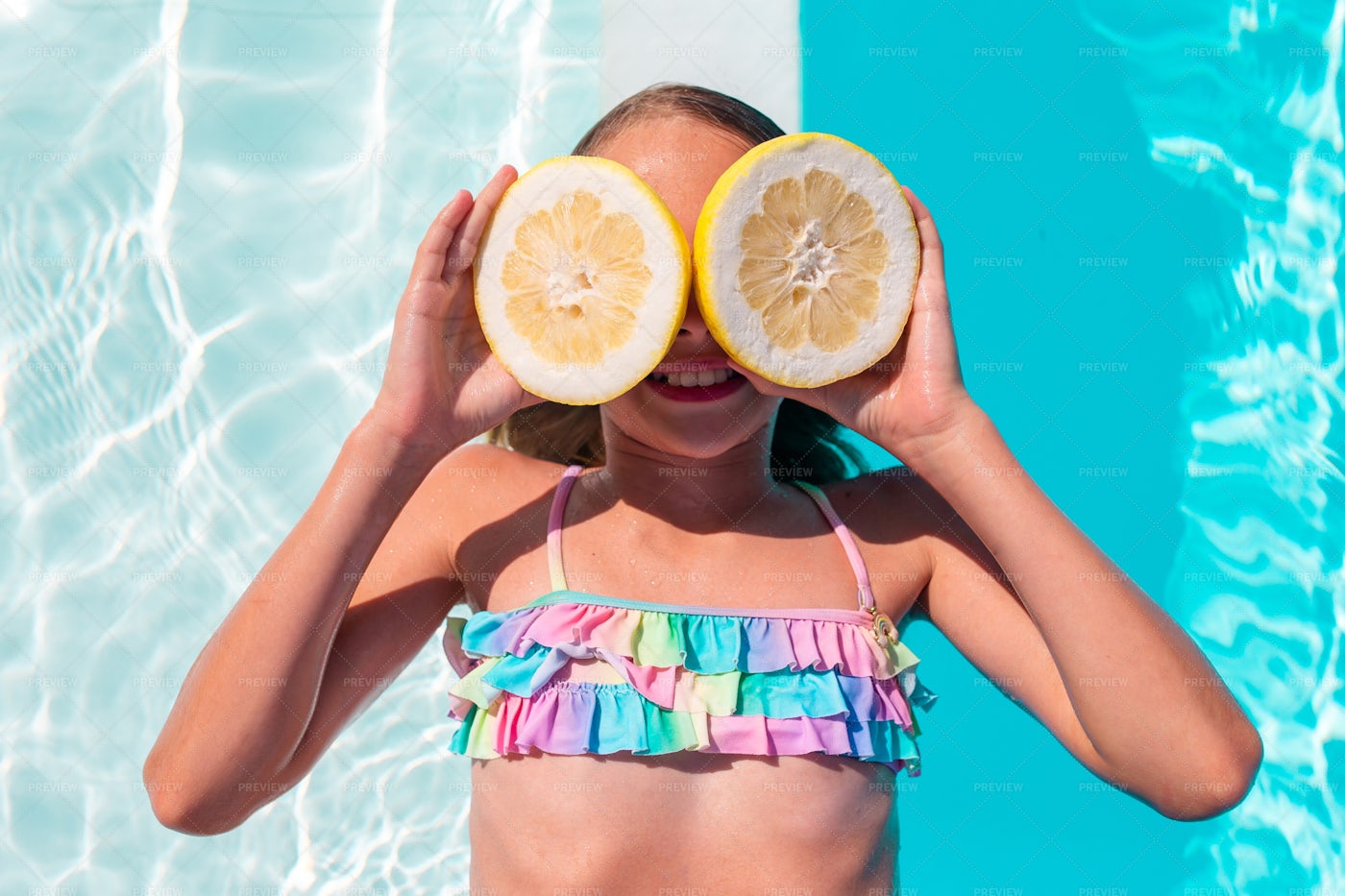 Little Kid Covering Eyes With Lemon: Stock Photos