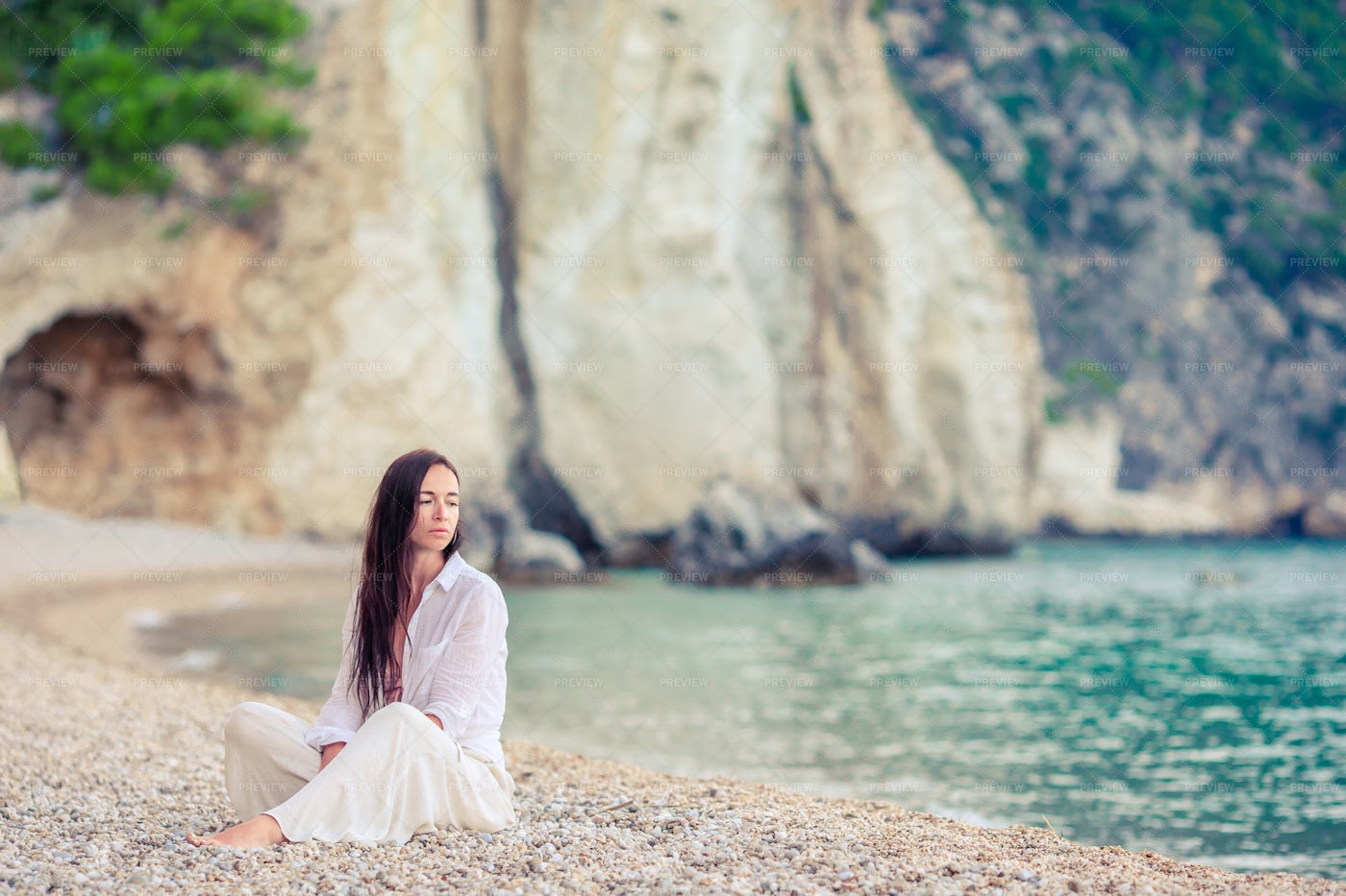 Woman Sitting On A Beach: Stock Photos