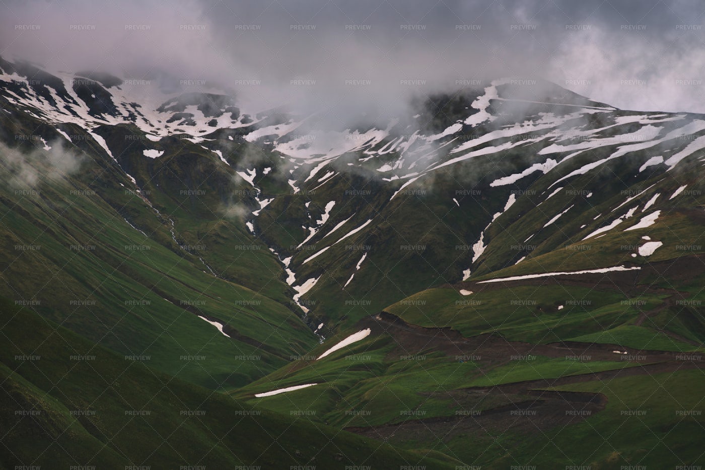 Green Mountains With Snow And Clouds: Stock Photos