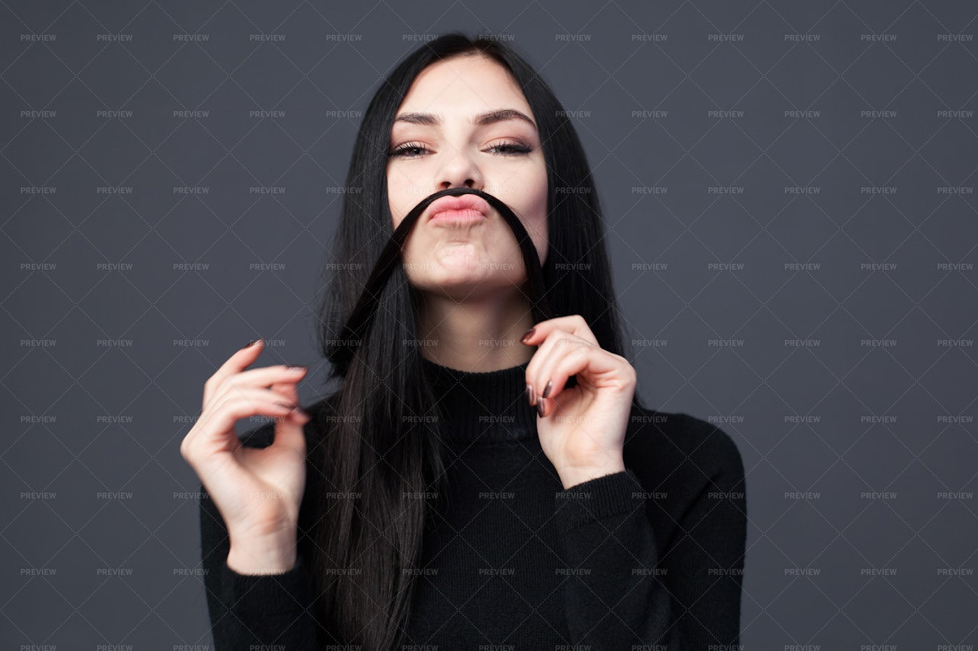 Woman Making A Mustache From Her Hair: Stock Photos