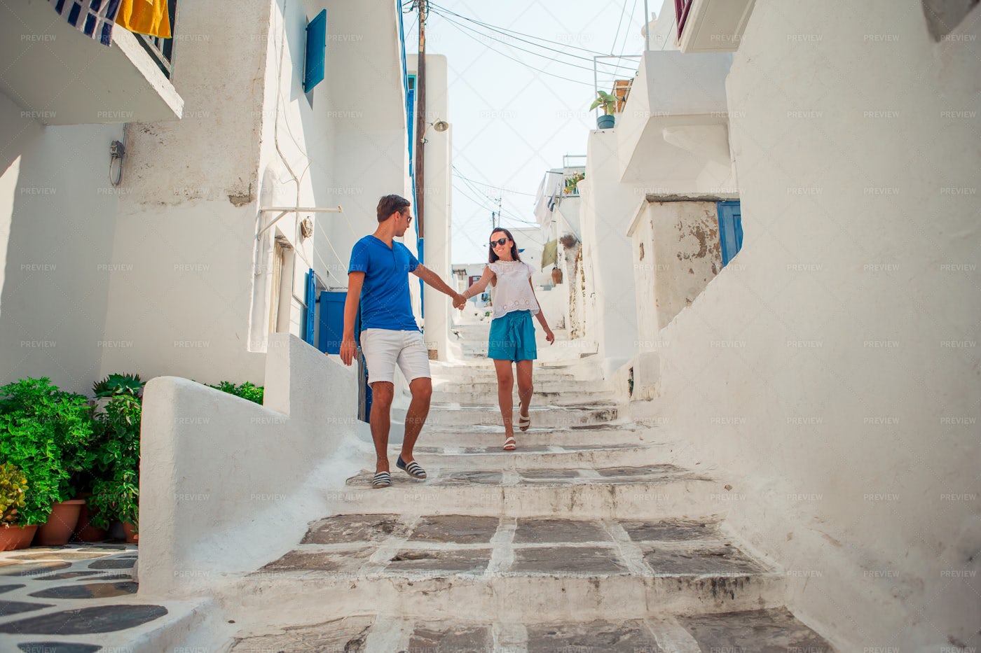 Couple Walking On A Greek Street: Stock Photos