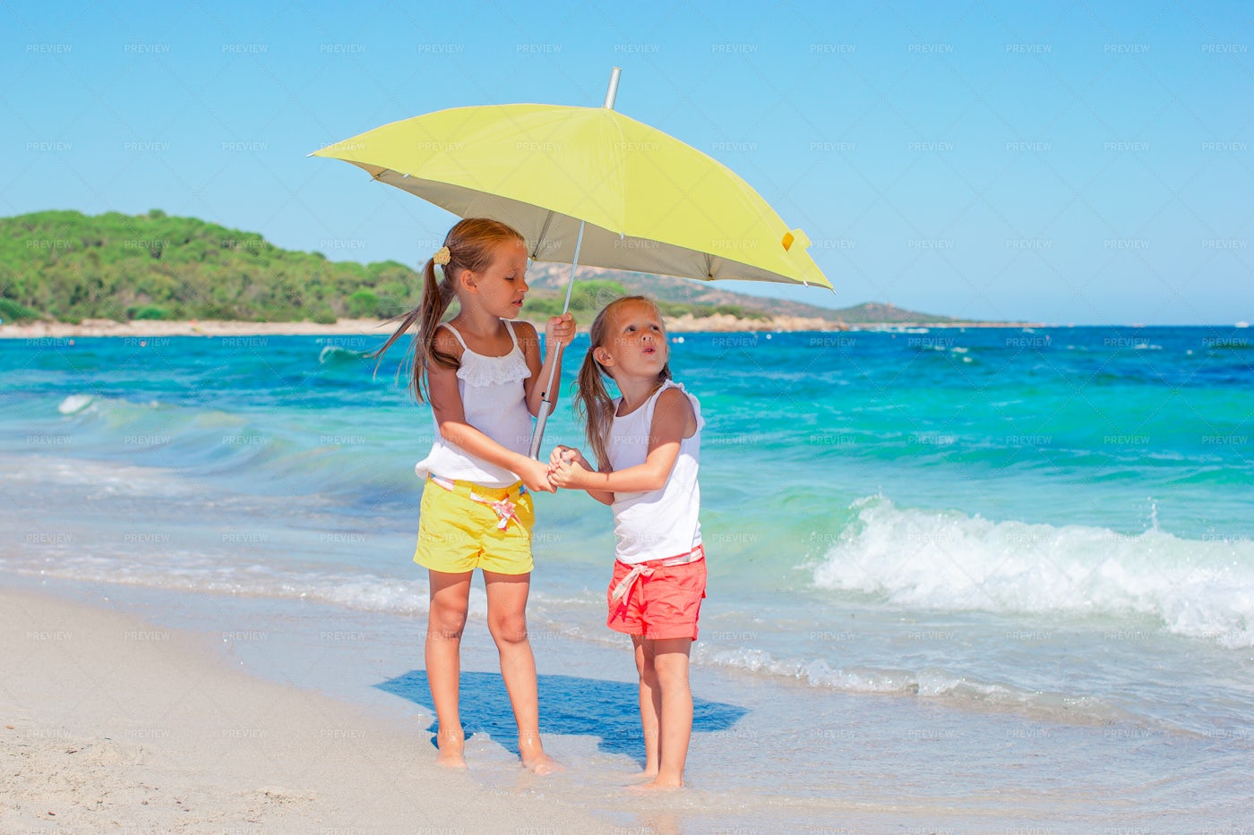 Kids With An Umbrella On The Beach: Stock Photos