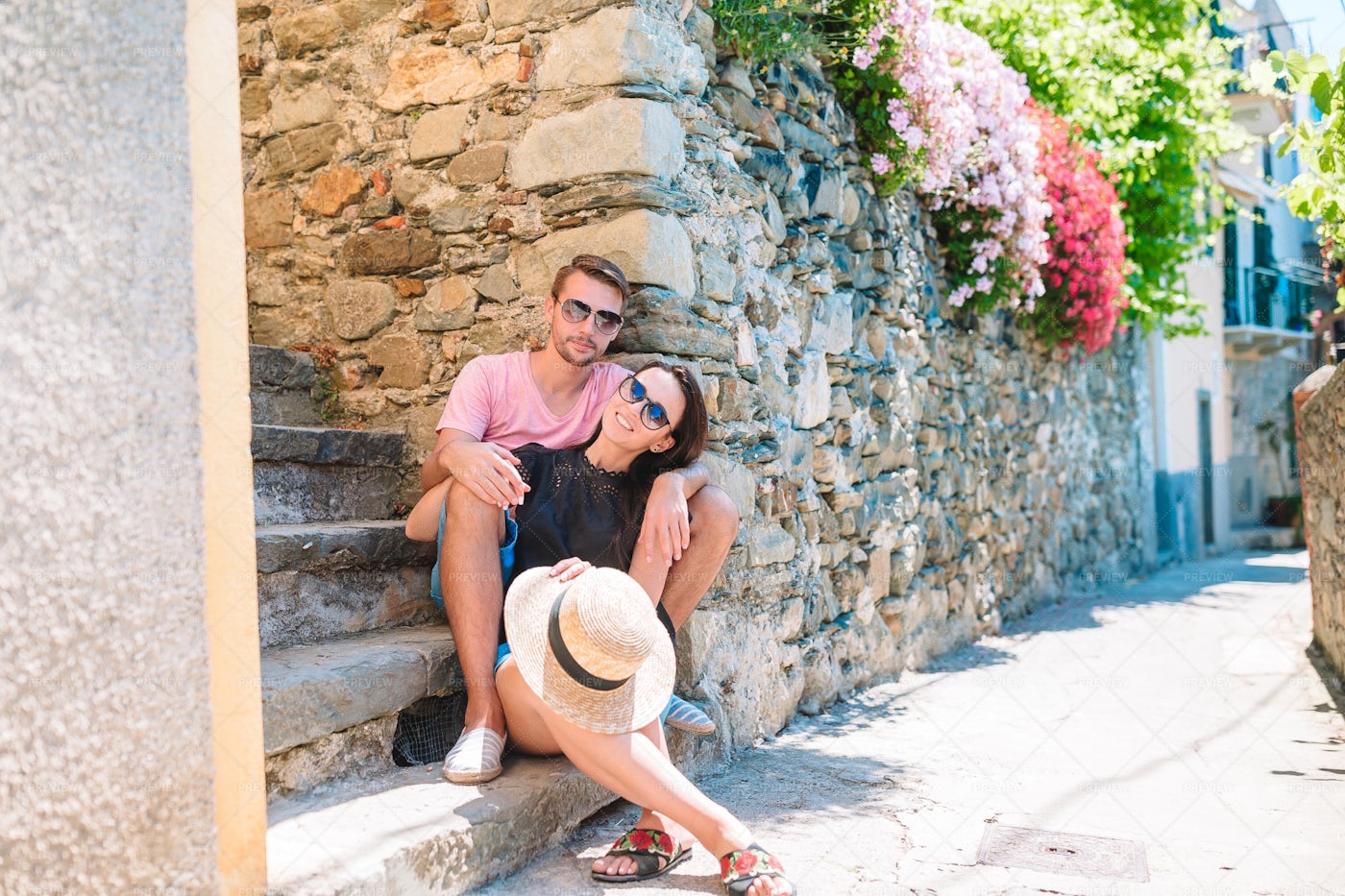 Couple Sitting On A Picturesque Street: Stock Photos