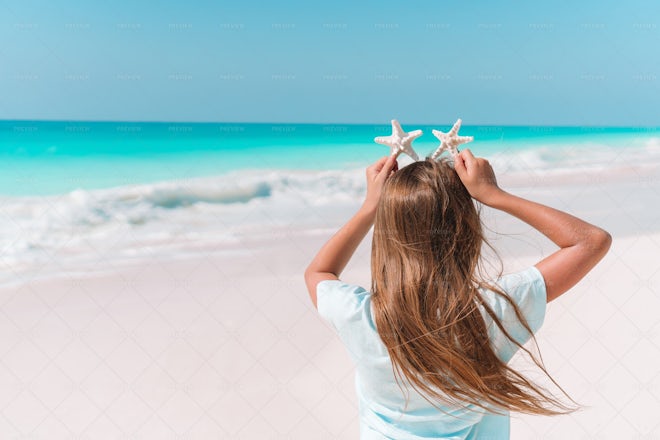 Adorable little girl at beach on her summer vacation Stock Photo by  travnikovstudio