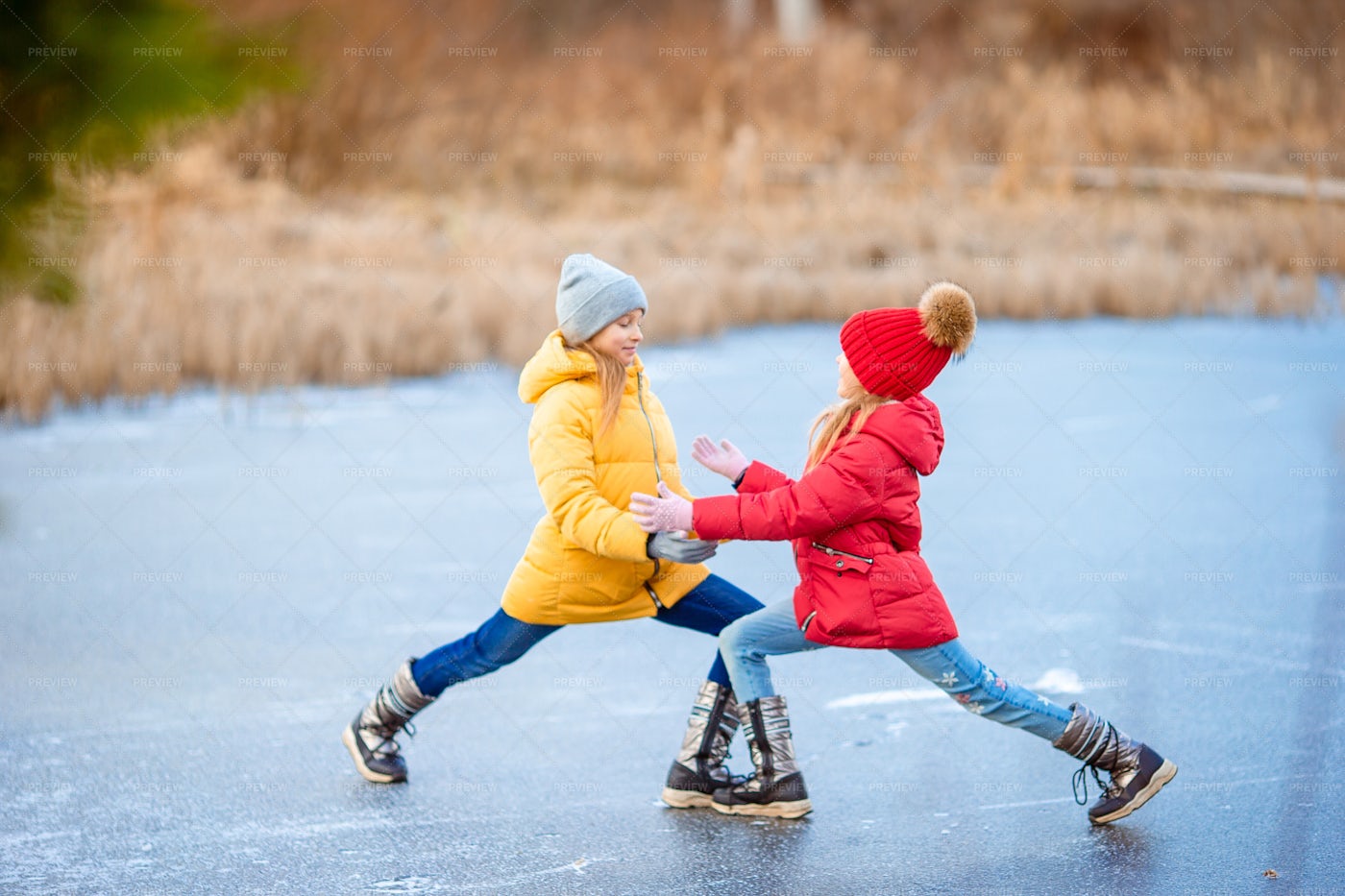 Sisters Skating On Ice: Stock Photos
