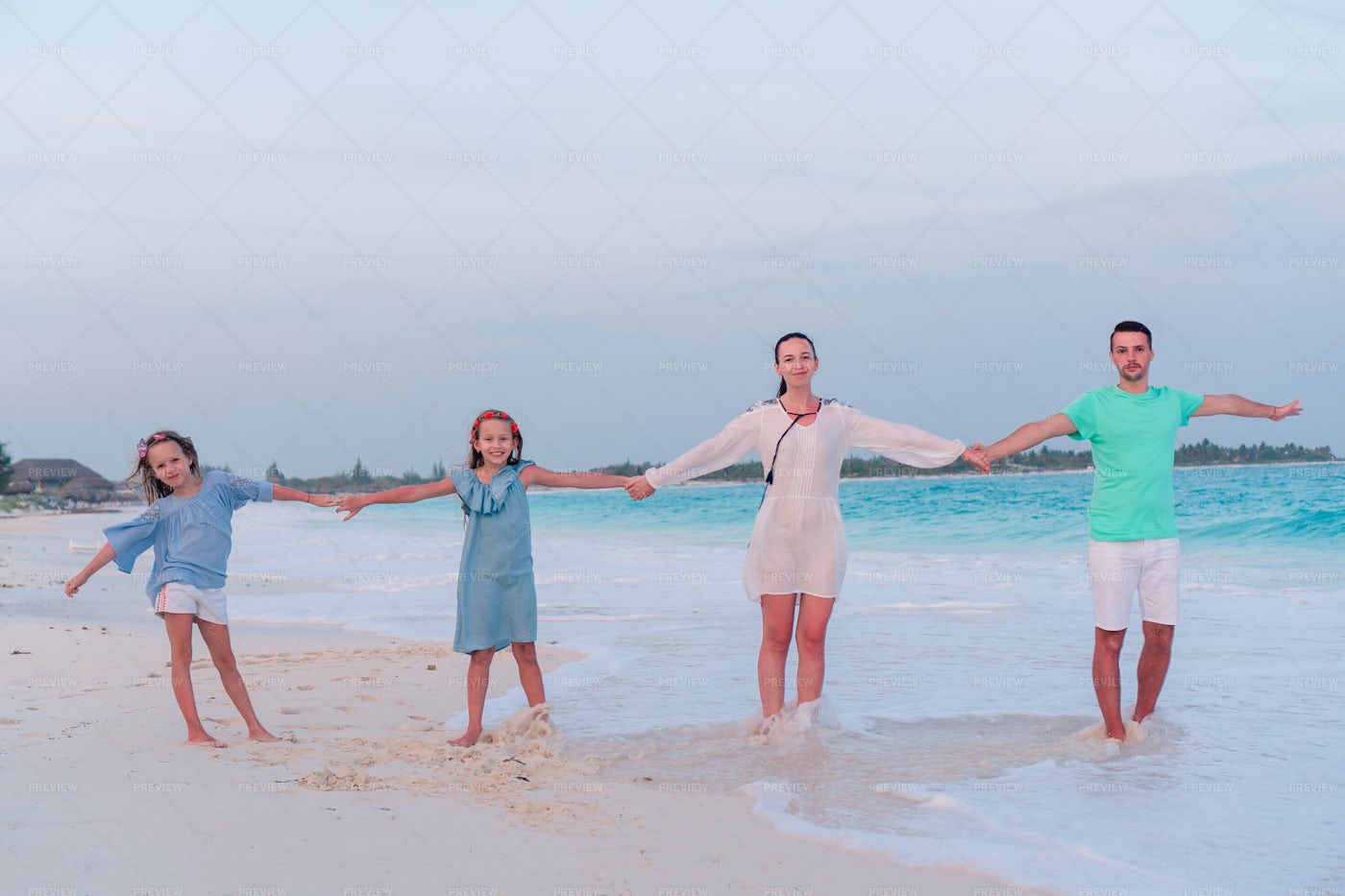 Family Holding Hands On The Beach: Stock Photos